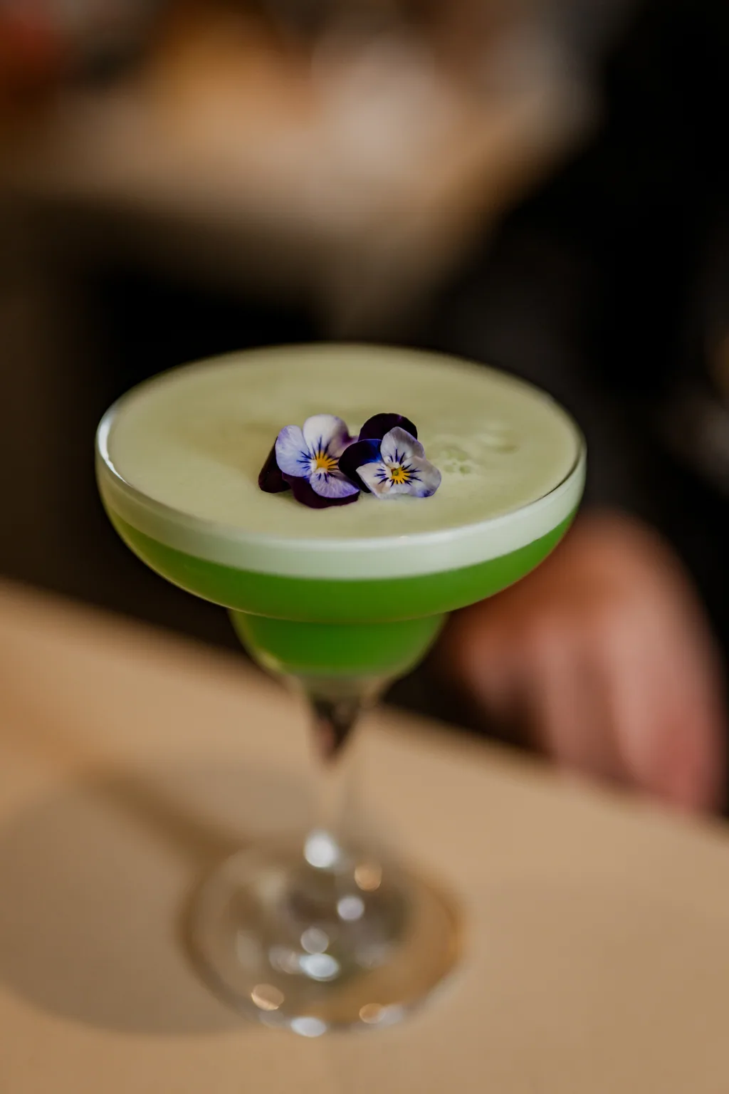 Cocktail com flor comestível no bar da casa